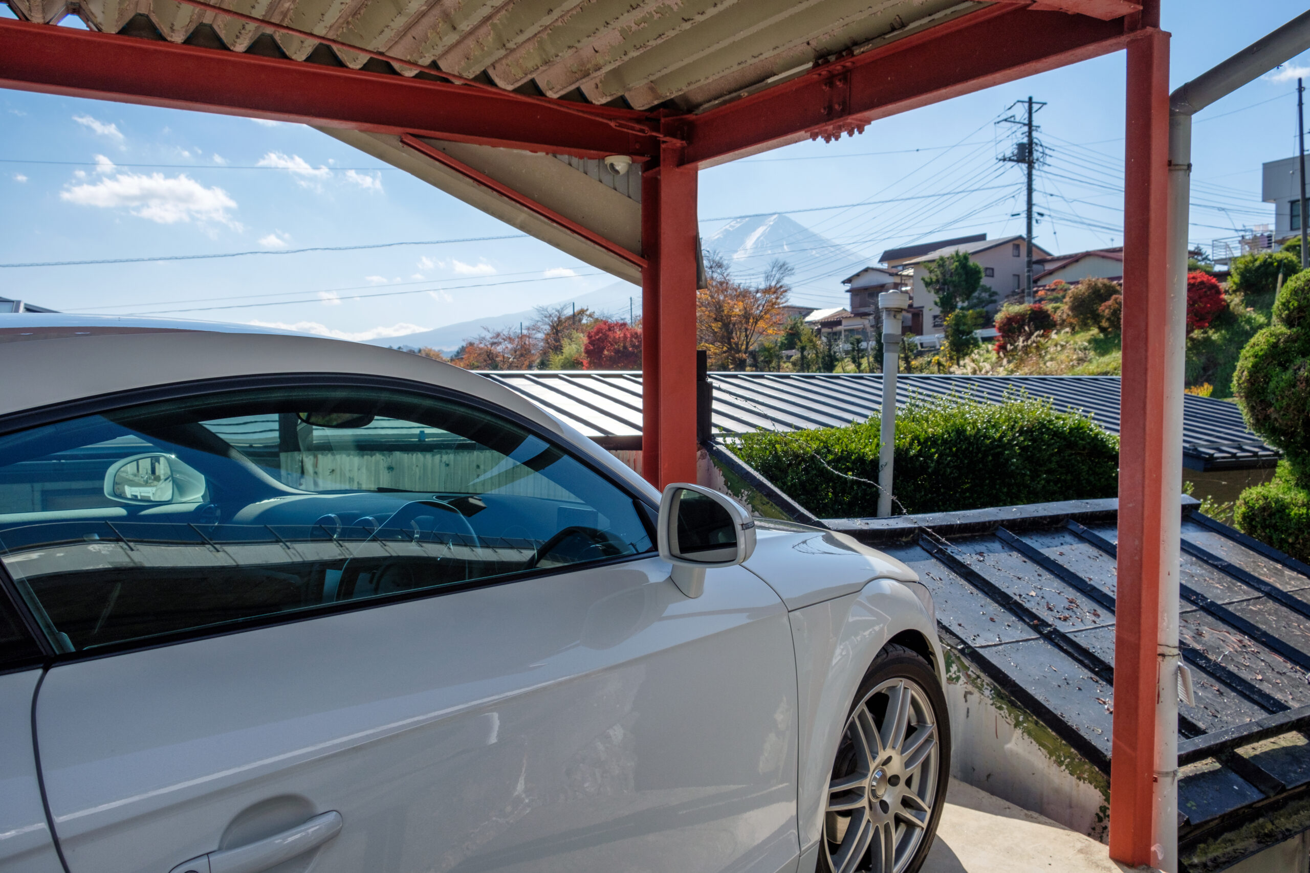 White modern sport car parked inside open garage and view Fuji-san mountain in autumn